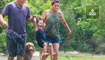 family jumping over water